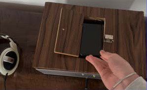 A hand placing a phone in the open hatch