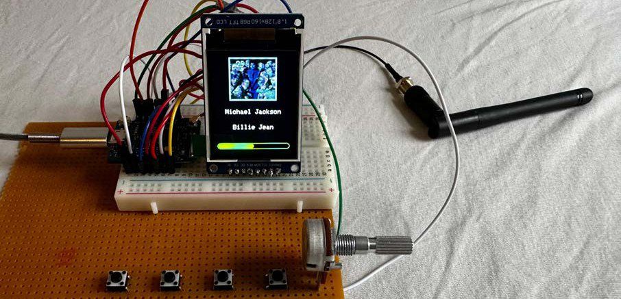 A breadboard with an ESP8266, a small display showing the album Billie Jean, a potentiometer and buttons